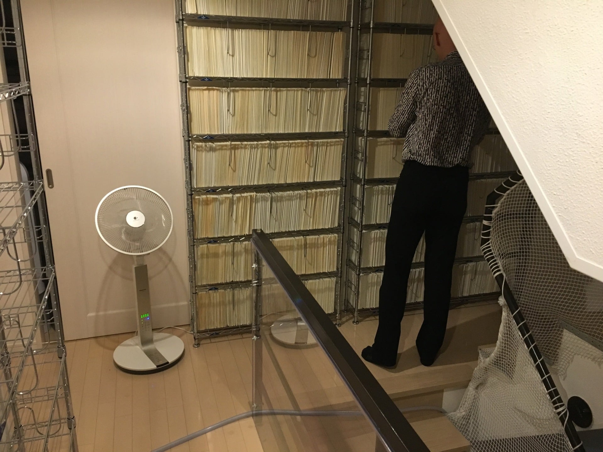 Redon files away game manuals in a carefully climate-controlled storage room.