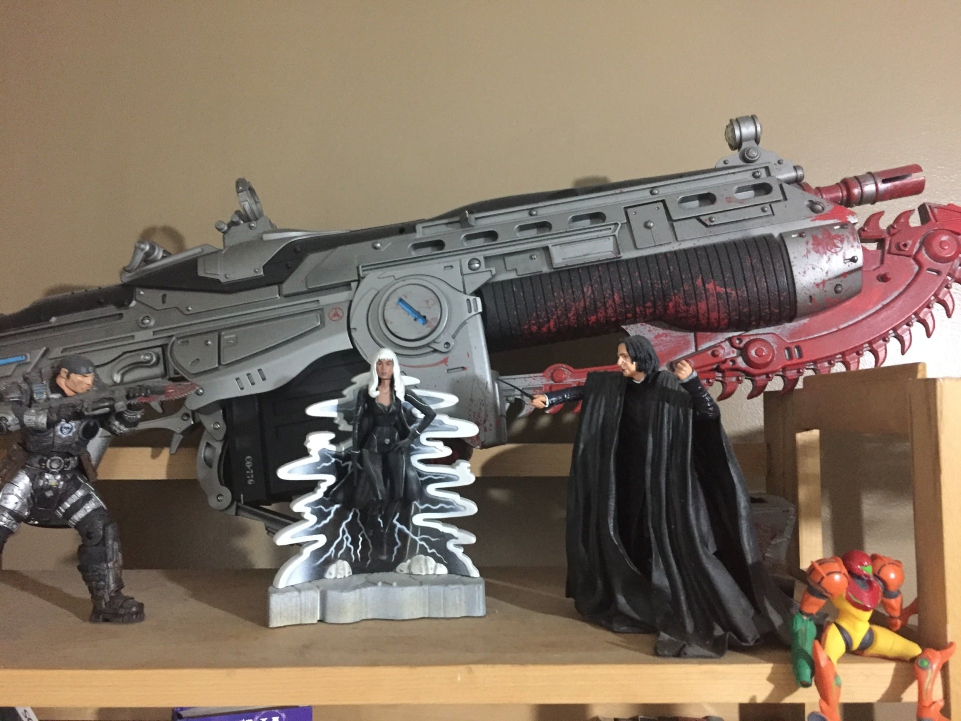 My bookshelf: Marcus Fenix, Storm, Professor Snape, Samus, and ... of course... the Lancer.