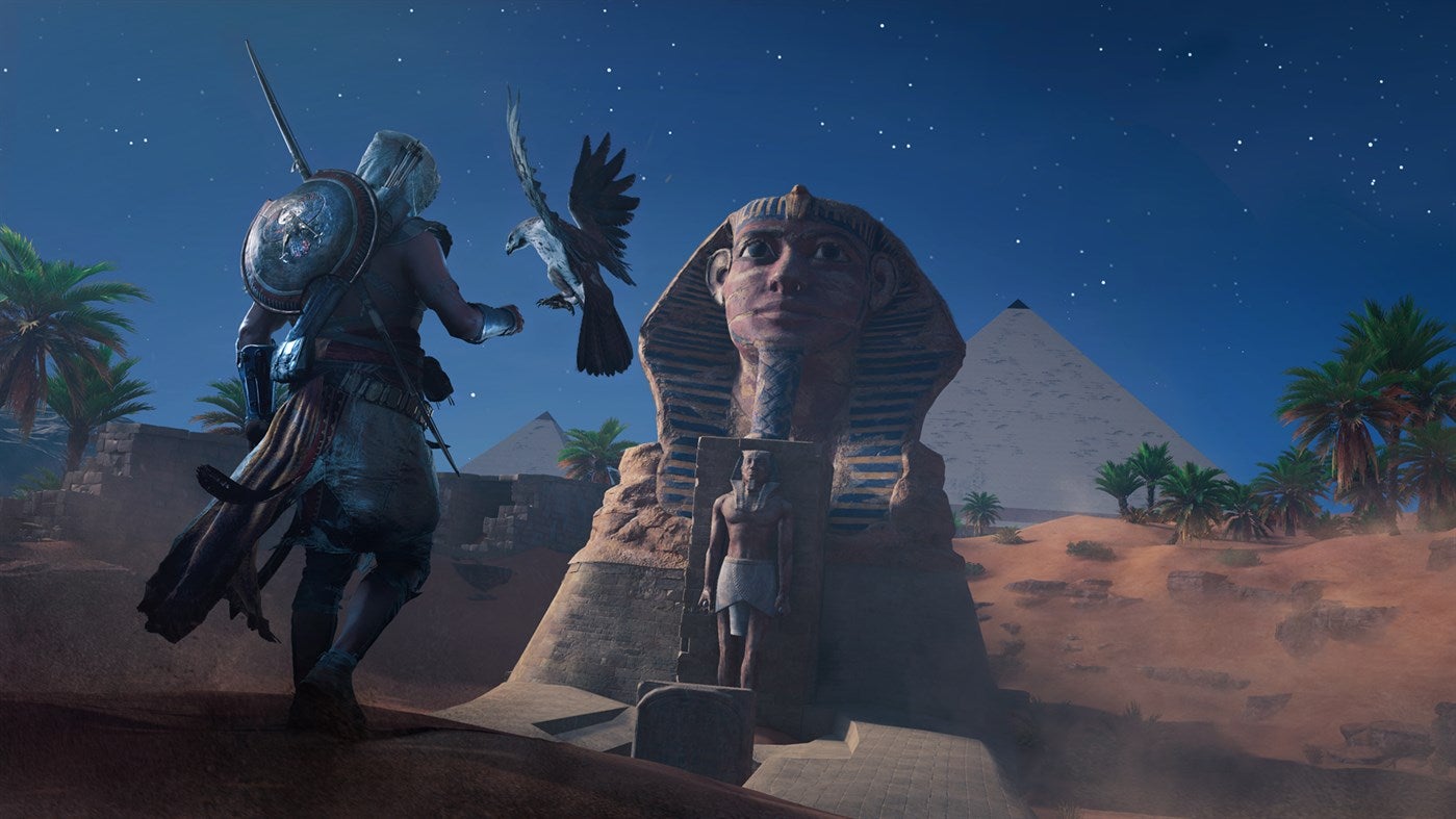Bayek and his faithful eagle, Senu, standing in front of the Great Sphinx of Giza.