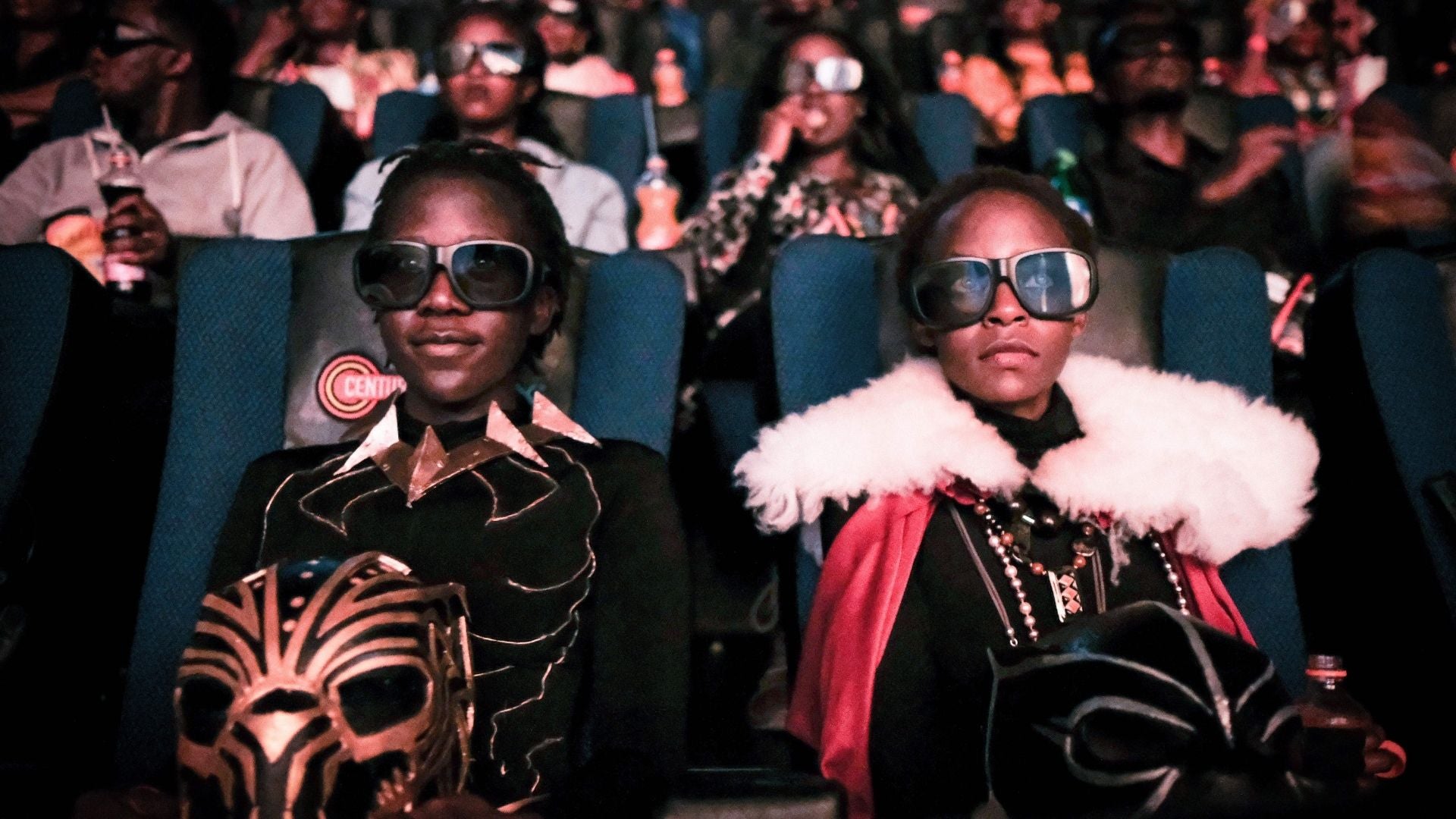 Like these bespoke looking children, I took my father, a person who does not typically watch superhero movies, to see Black Panther dressed in the biggest African print skirt I owned. 