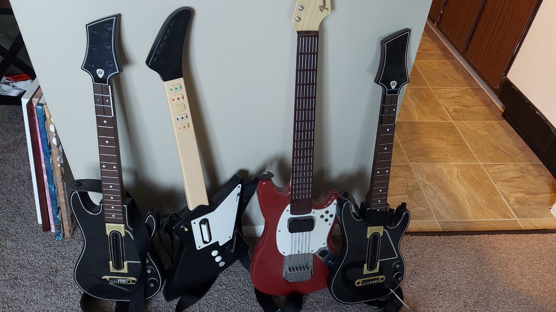 My partner has a lot of guitars, only the one second from the left works. 