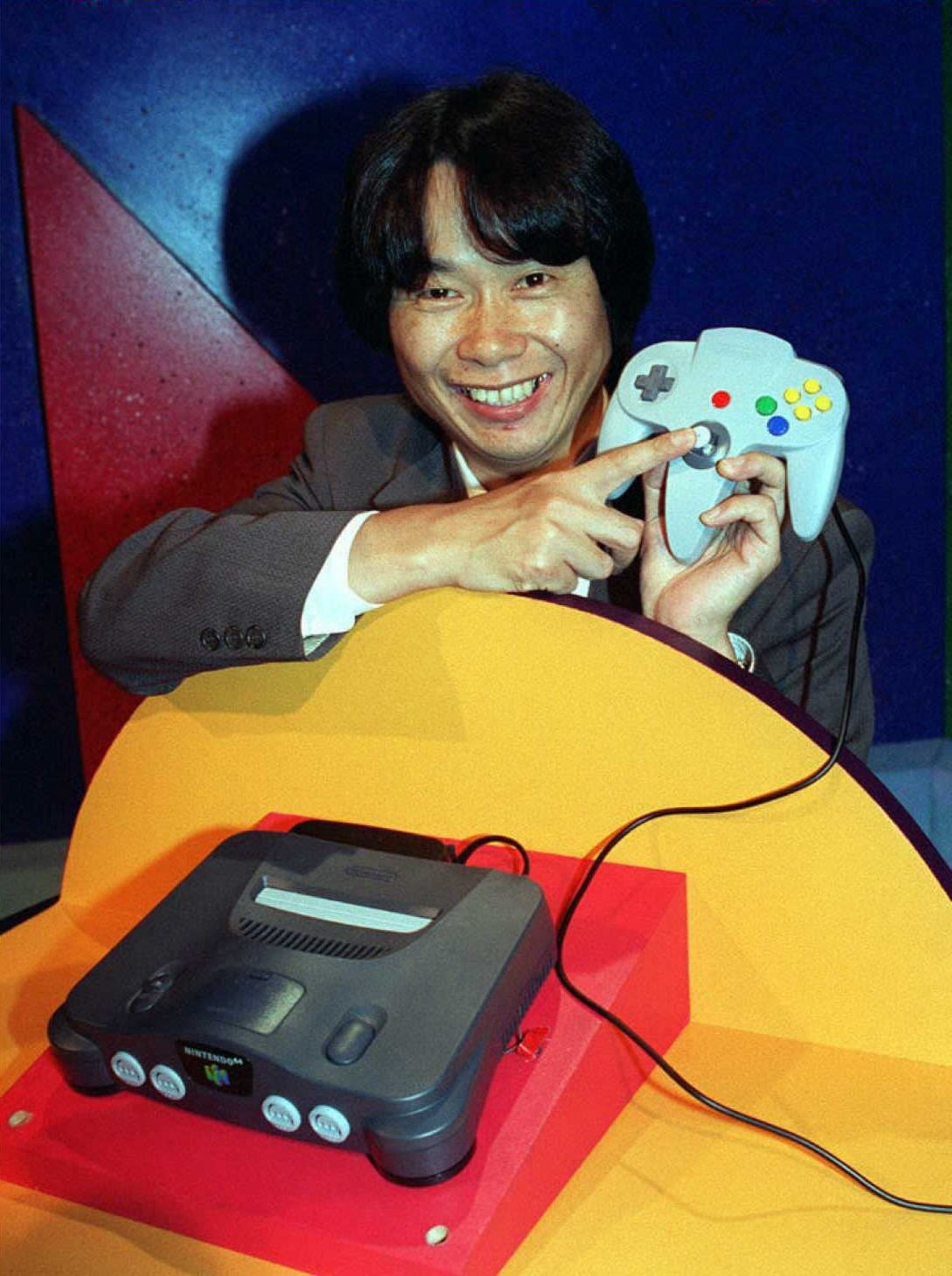 Shigeru Miyamoto shows off the Nintendo 64 and its controller.