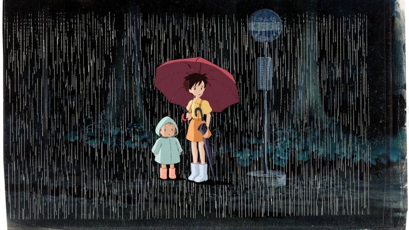 Mei and Satsuki wait at the bus stop in Studio Ghibli’s My Neighbor Totoro.