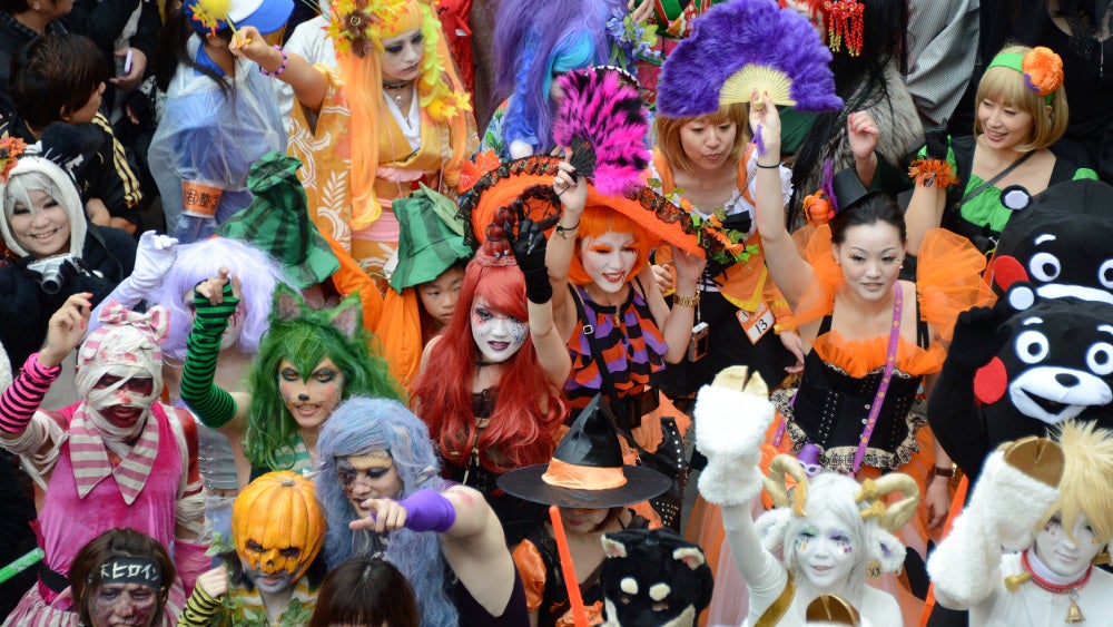 An array of costumes at a Halloween parade.
