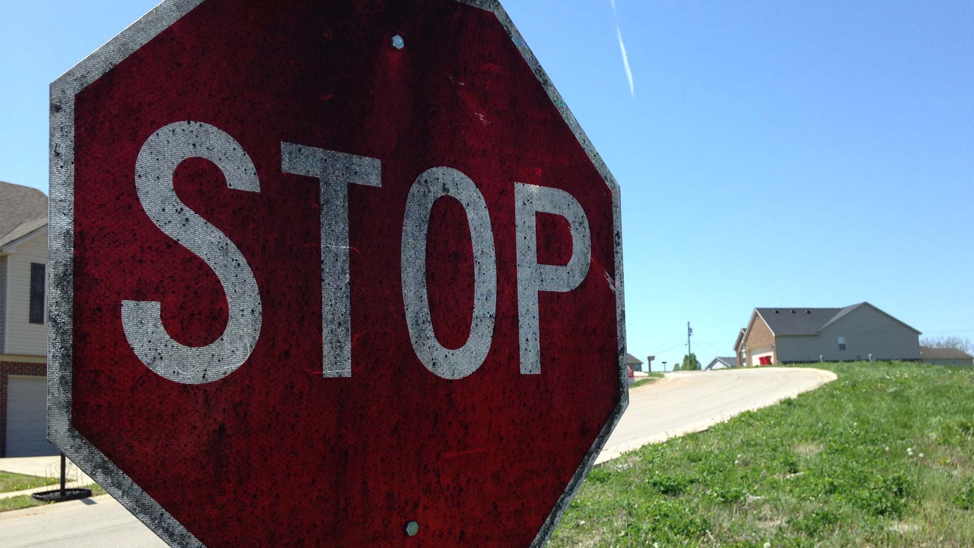 A stop sign from 2014 covered in whiskey fungus