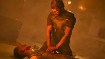 A man performs CPR on someone.