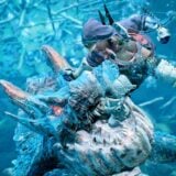 A hunter fights under water.