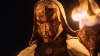 A masked man performs a ritual.