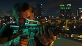 A man holds up a rifle in a city.