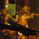 Men in chem suits put out fires.