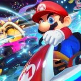 Mario races Bowser on Rainbow Road.