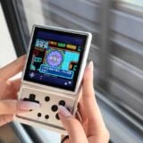 Someone holds a GBA emulator on a train.