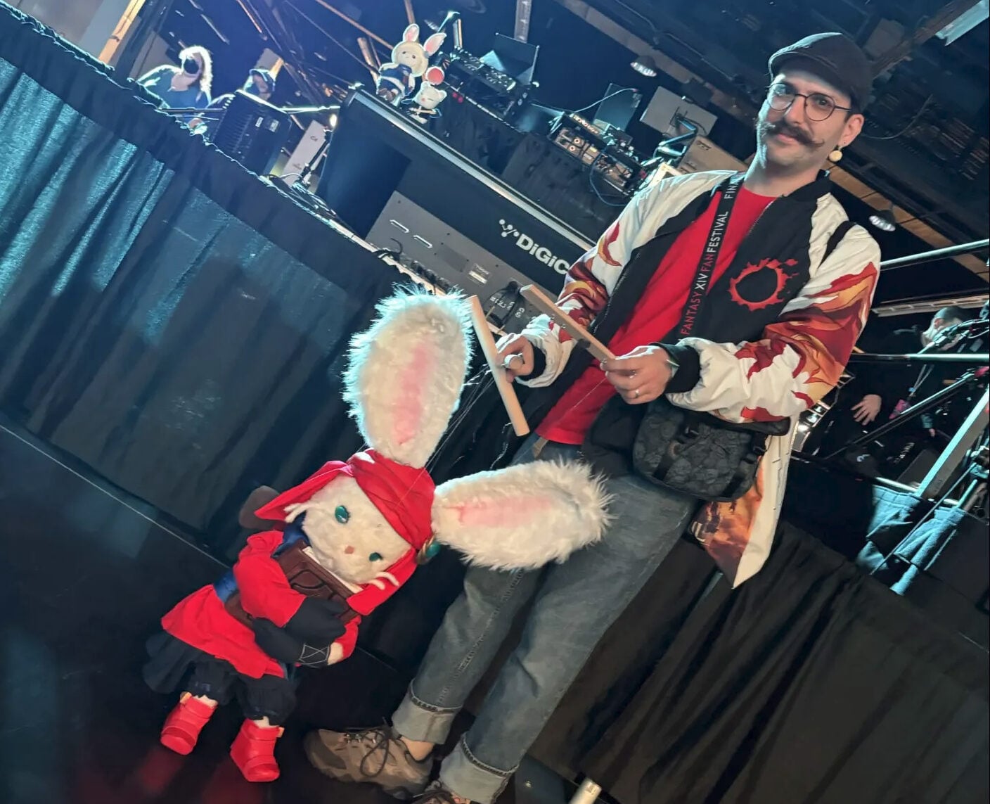 A person stands next to a giant mouse.