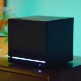 A Steam Machine sits next to a fish bowl.