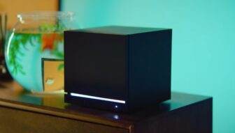 A Steam Machine sits next to a fish bowl.