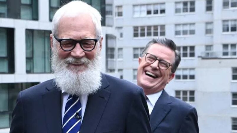 Stephen Colbert and David Letterman laugh.