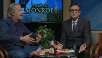 Stephen Colbert shrugs on the set.