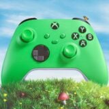 A green Xbox controller sits on a hill.