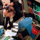 A stock trader puts his head in his hands.