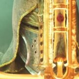 A Paladin holds up a sword.