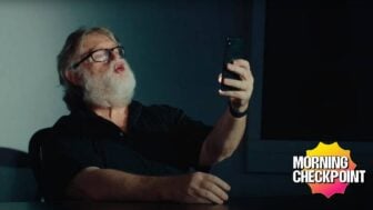 Gabe Newell looks at his phone.