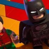 Batman and Robin look up at the ceiling.