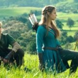 Link and Zelda sit in a field.