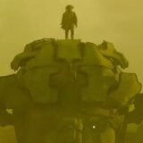 A figure stands on a robot in a sandstorm.