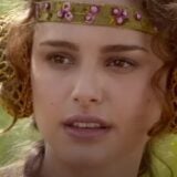 Padme looks confused in a grassy field.