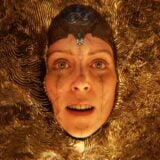 A woman appears in a gold mesh.