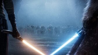 Light sabers appear in a dark area.