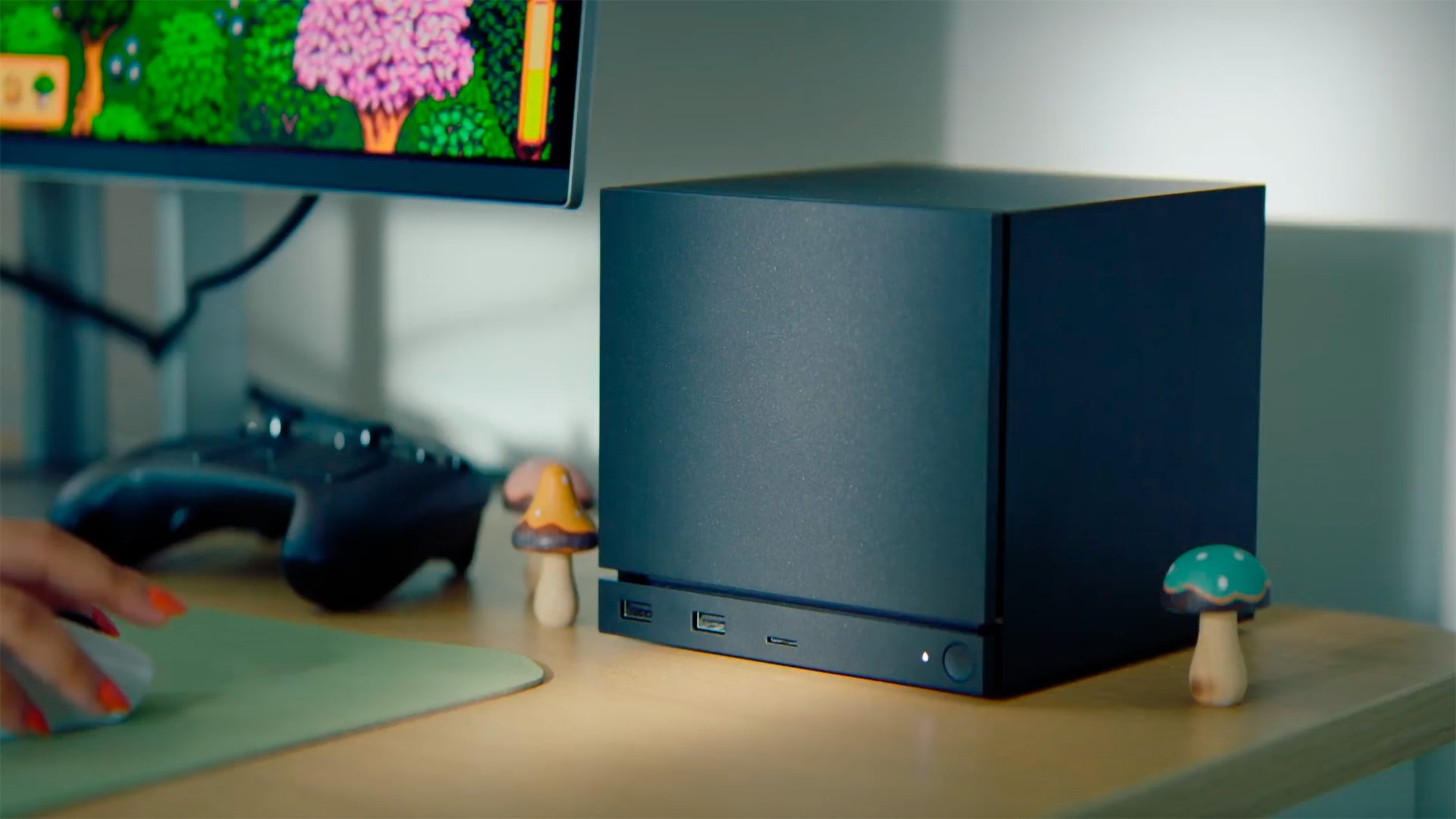 A Steam Machine sits on a desk.