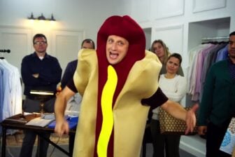 A man wears a hot dog costume.