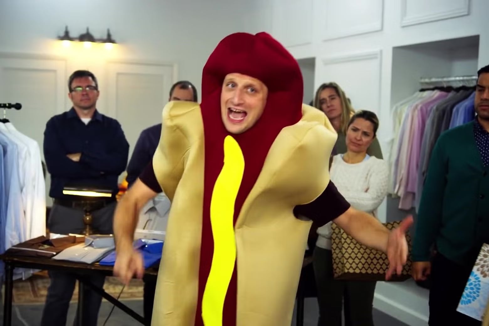 A man wears a hot dog costume.