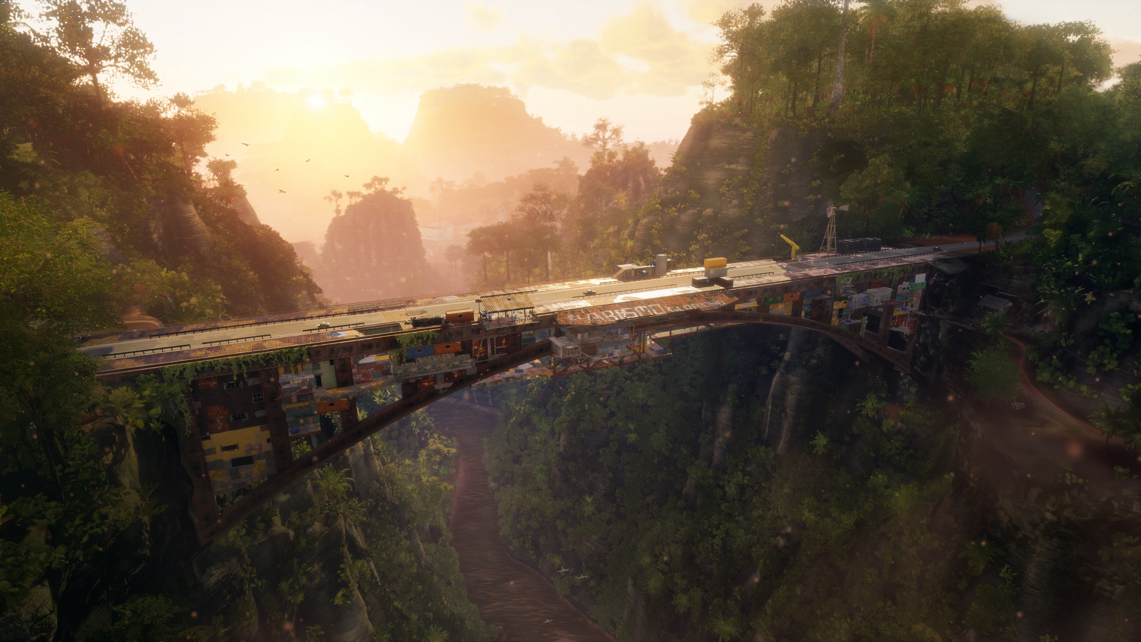Just Cause 4 environment screenshot: huge bridge over rainforest canyon at sunset